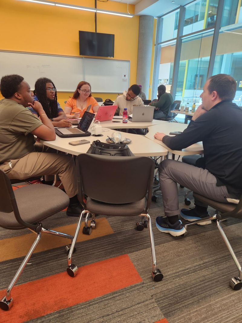 Bowie State Students and Professor Discussing Ideas about the Event at a Table