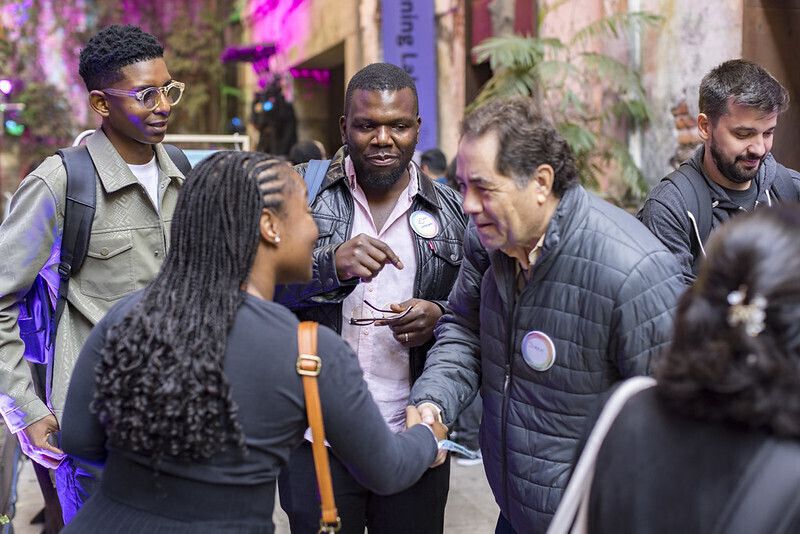community members shaking hands at the Summit