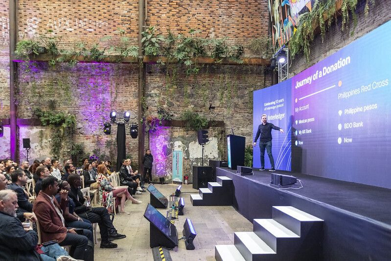 Interledger developer presenting in front a crowd