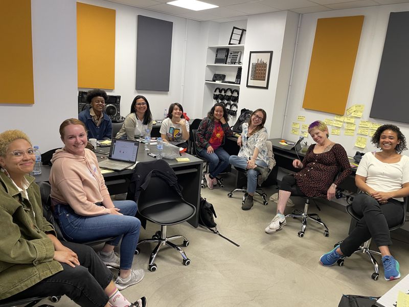 the group sitting and smiling while at work during the Design Sprint