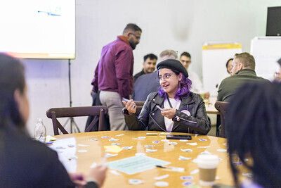 During the Interledger Summit workshop about gig workers and fianncial justice, people are discussing happily