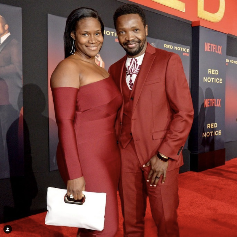 April and Ivan Mbakop rocking a red dress and red suit on the red carpet for the premiere of Netflix's Red Notice.