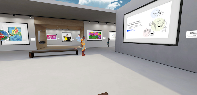 A couple of attendees looking at the art in the Interledger Community Gallery in Spatial