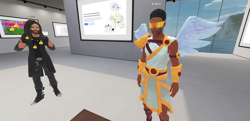 Coma sharing a thumbs up in the Interledger Community Gallery in Spatial, after he and an angel clad Bjorn enjoy a dance off