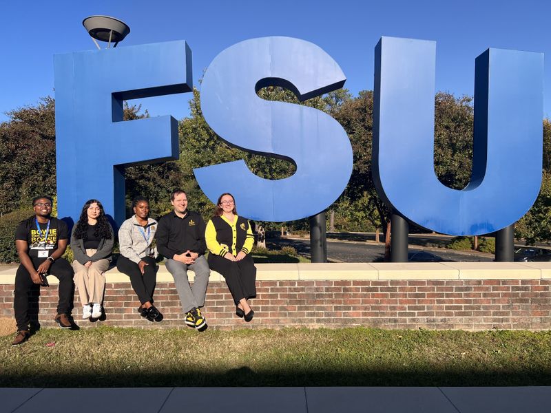 Bowie State University Students at Fayetteville State University in front of an FSU sign on campus
